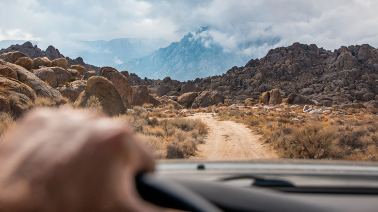 The view of a desert and mountainous landscape out the windshield of an offroad vehicle in California, US.