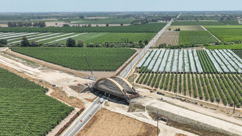 Aerial view of the construction of a bridge over agricultural fields