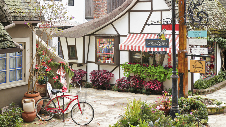A red bicycle sits in front of the fairy tale cottages of Carmel-by-the-Sea, California