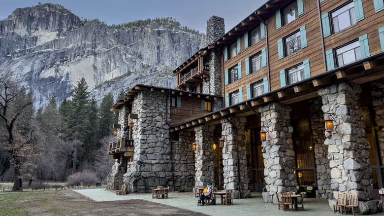 Exterior of the Ahwahnee lodging building in Yosemite National Park, surrounded by mountains