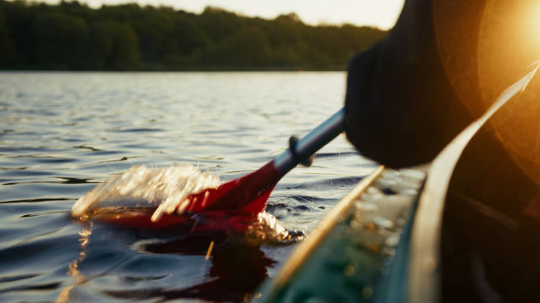 close up view of a kayaker paddling in the water