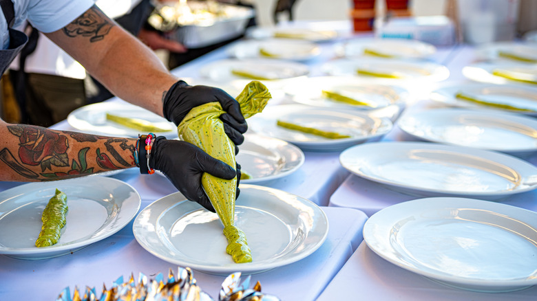 A chef prepares a plate at the annual Tower Bridge Dinner in Sacramento, California