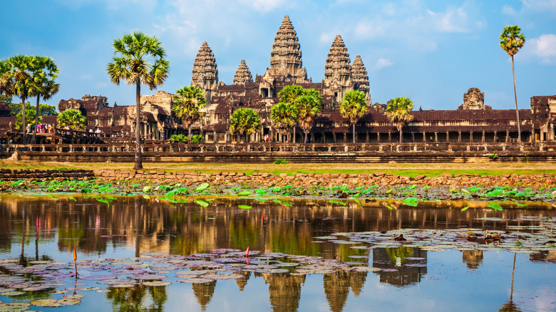 The iconic beehive towers of Angkor Wat reflected in its moat
