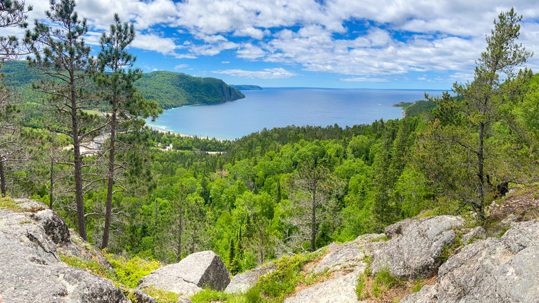 panoramic view of blue lake and pine forest from cliff in Lake Superior Provincial Park