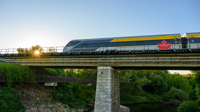 a train running on a bridge near lake ontario