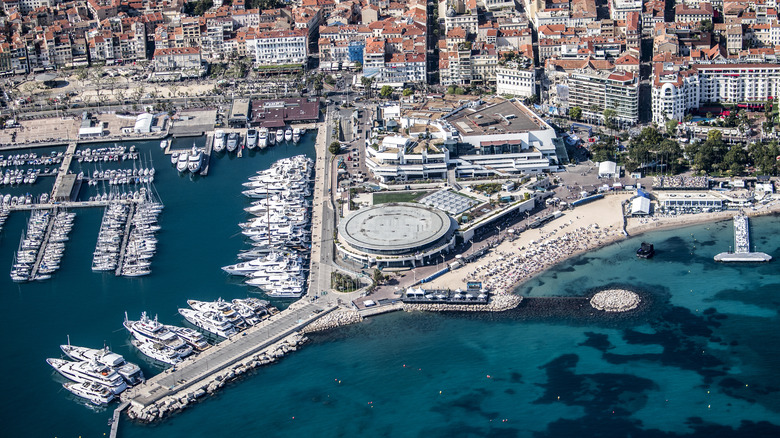 Panoramic aerial view of Cannes, France with yachts, beaches, and glamorous buildings visible