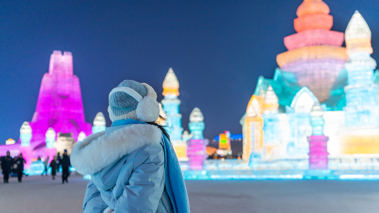 A woman admiring the Snow and Ice Festival in Harbin