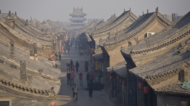 Pedestrians walking in the preserved ancient walled city of Pingyao