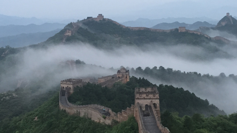 Fog rising from the forested hills at the Jinshanling section of the Great Wall