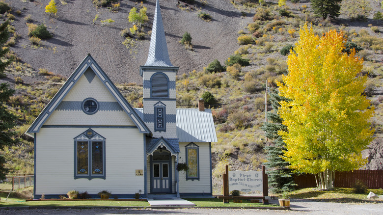A historic wooden church in Lake City, Colorado, with autumnal aspens