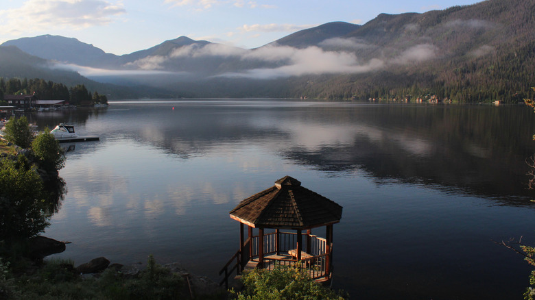 foggy sunrise over grand lake with gazebo in foreground