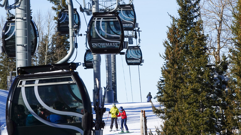 Skiers ride the Elk Camp Gondola at Snowmass ski resort in Aspen, Colorado.
