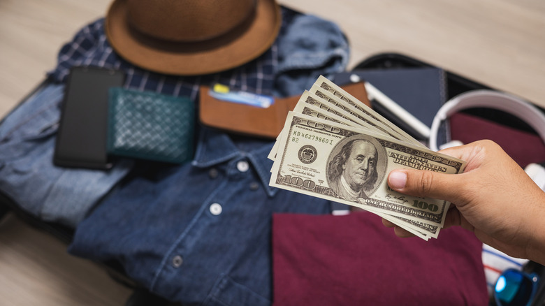 A man preparing cash for his trip