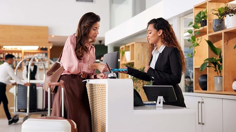 A woman checking into a hotel