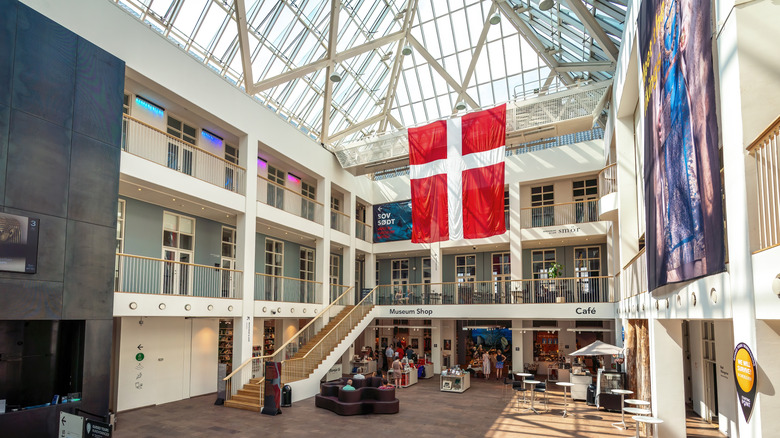 Multi-level glassed atrium with large Danish flag at the Danish National Museum in Copenhagen