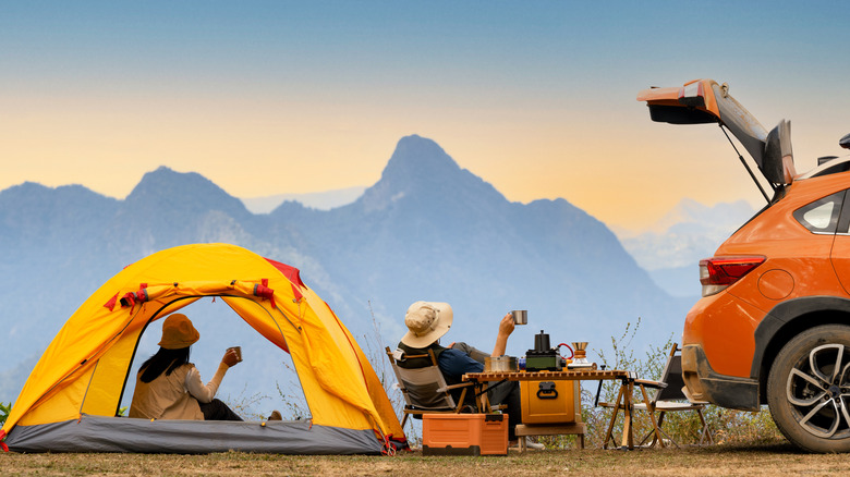 People camping with tent and car