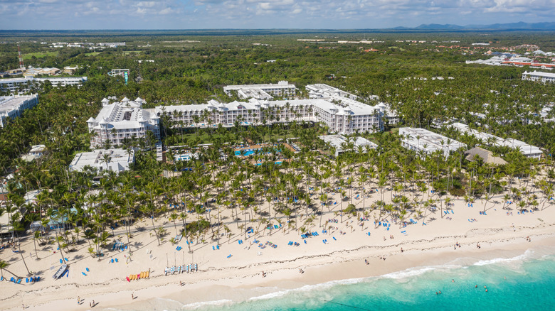 Aerial view of a beach resort surrounded by palm trees
