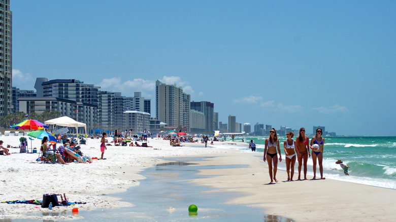 People and resort buildings along the beach at Panama City Beach, Florida