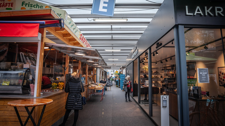 A row of Carlsplatz Market stalls with shoppers browsing