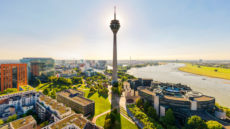 Aerial view of Dusseldorf with the Rhine Tower at the center and the Rhine River on the right on a bright, sunny day