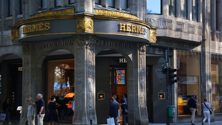 People walk by Hermes's luxury storefront in Dusseldorf, Germany