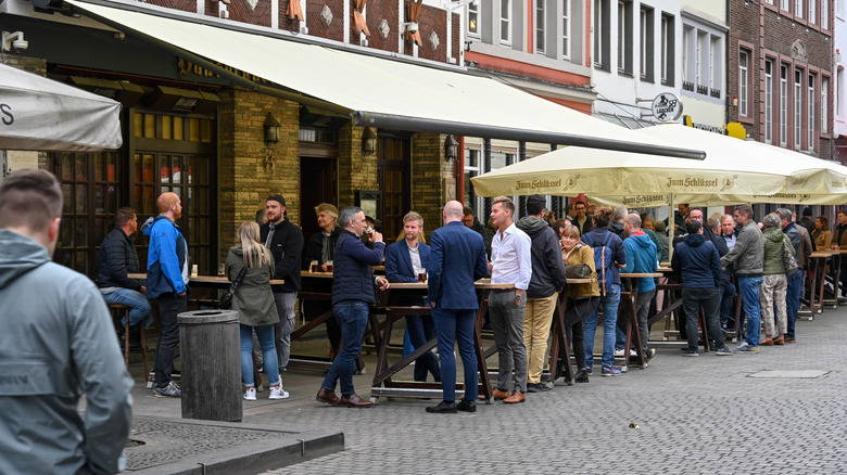 People standing outside a pub in Dusseldorf's Old Town