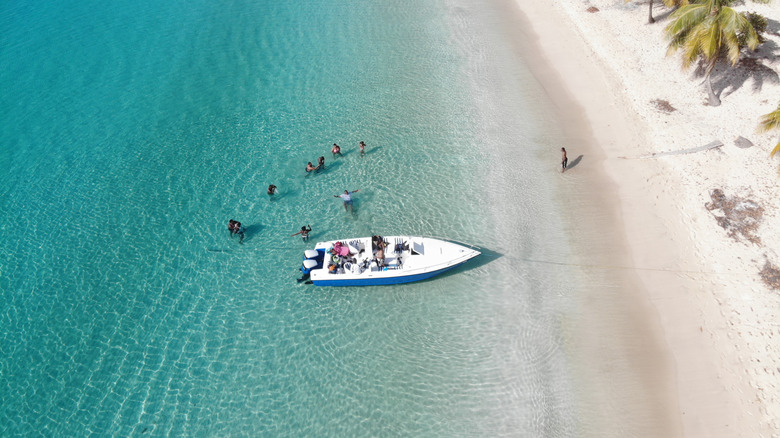 Drone view of swimmers near a boat in Salt Whistle Bay on the Island of Mayreau.