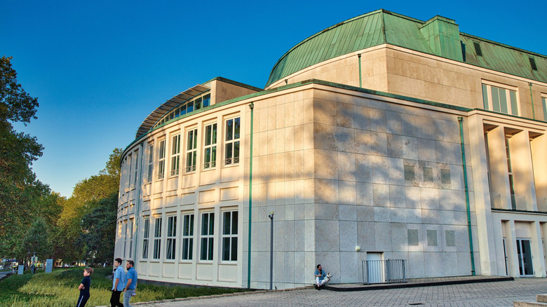 People walking outside of the Philharmonie Essen building