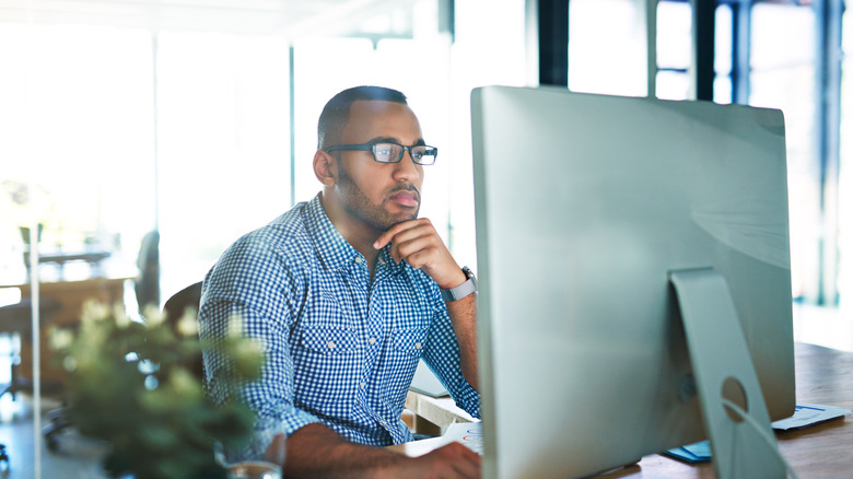 Cropped shot of a handsome young businessman working in his office