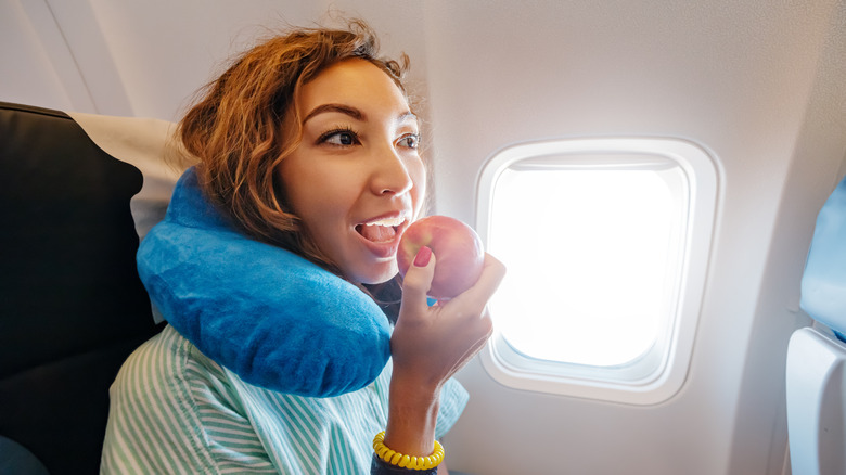 Someone eating on a plane