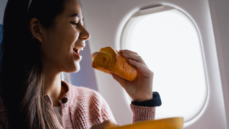 Someone eating on a plane