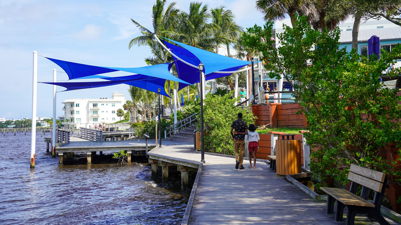 A man and young girl stroll on the boardwalk at Riverwalk Park in Stuart, Florida
