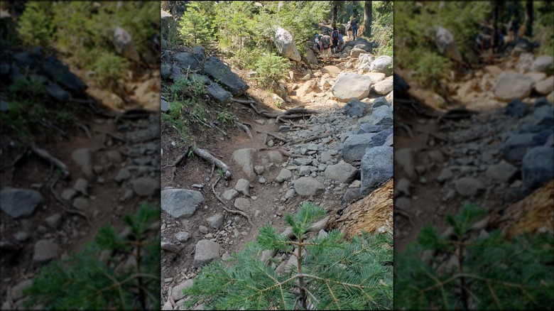 Hikers climbing the rocky trail leading to Loch Leven Lakes