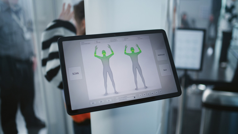 A tablet computer screen displays a silhouette outline as the results for a full-body scanner at an airport.
