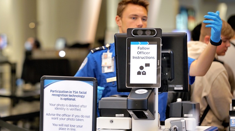 A TSA officer working at a CAT-2 machine at an airport security checkpoint