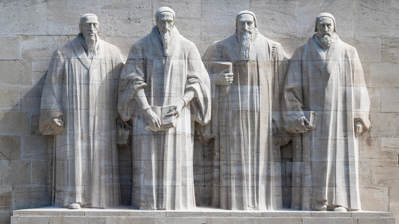 Row of four statues at the Reformation Wall in Geneva