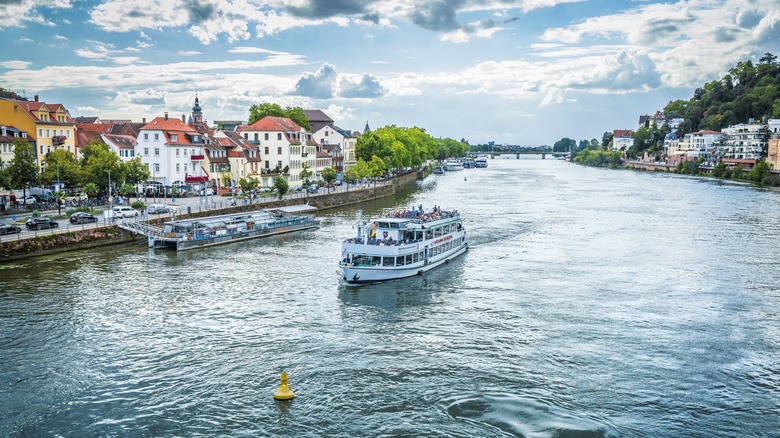 A river boat cruises down the Neckar River in Heidelberg