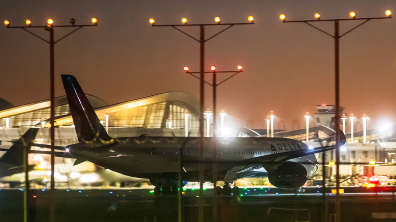 An airplane taxiing at LAX at night