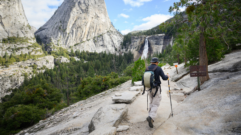 Man hiking John Muir trail towards Vernal Falls, Yosemite National Park. California. USA.