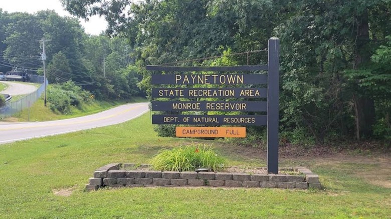 A sign for Paynetown State Recreation Area next to a two-lane road