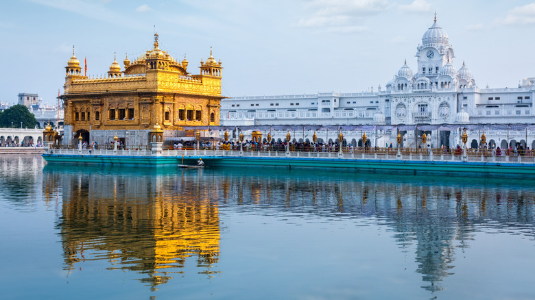 The Golden Temple reflected in the river in Amritsar, India