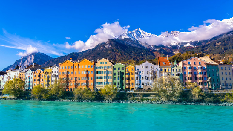A panoramic photo of colorful buildings along the river in Innsbruck
