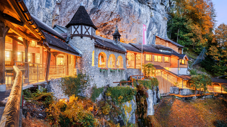 A chalet illuminated at night built into a mountain