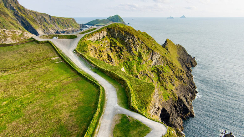 Aerial view of green hills and the Atlantic Ocean along the famous Ring of Kerry driving route in Ireland