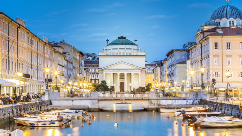 San Antonio Church in the background and a canal in the foreground illuminated at night