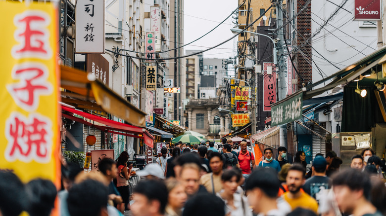 People walking through stalls at Tsukiji Fish Market