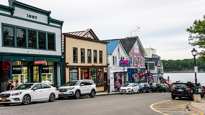 Main street in Bar Harbor downtown with two-story buildings and parked cars