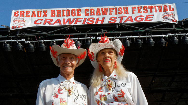An older man and woman dressed beautifully during a crawfish festival in Breaux Bridge
