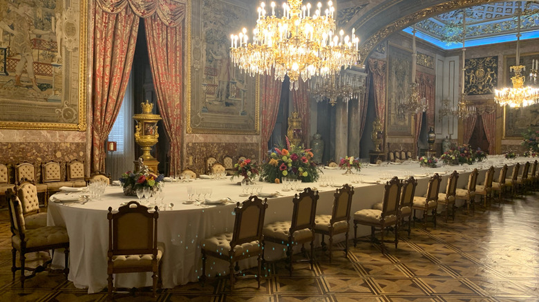 interior dining room with long table many chairs and chandeliers