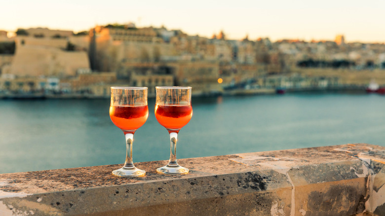 Two glasses of wine set on a stone wall in Valletta